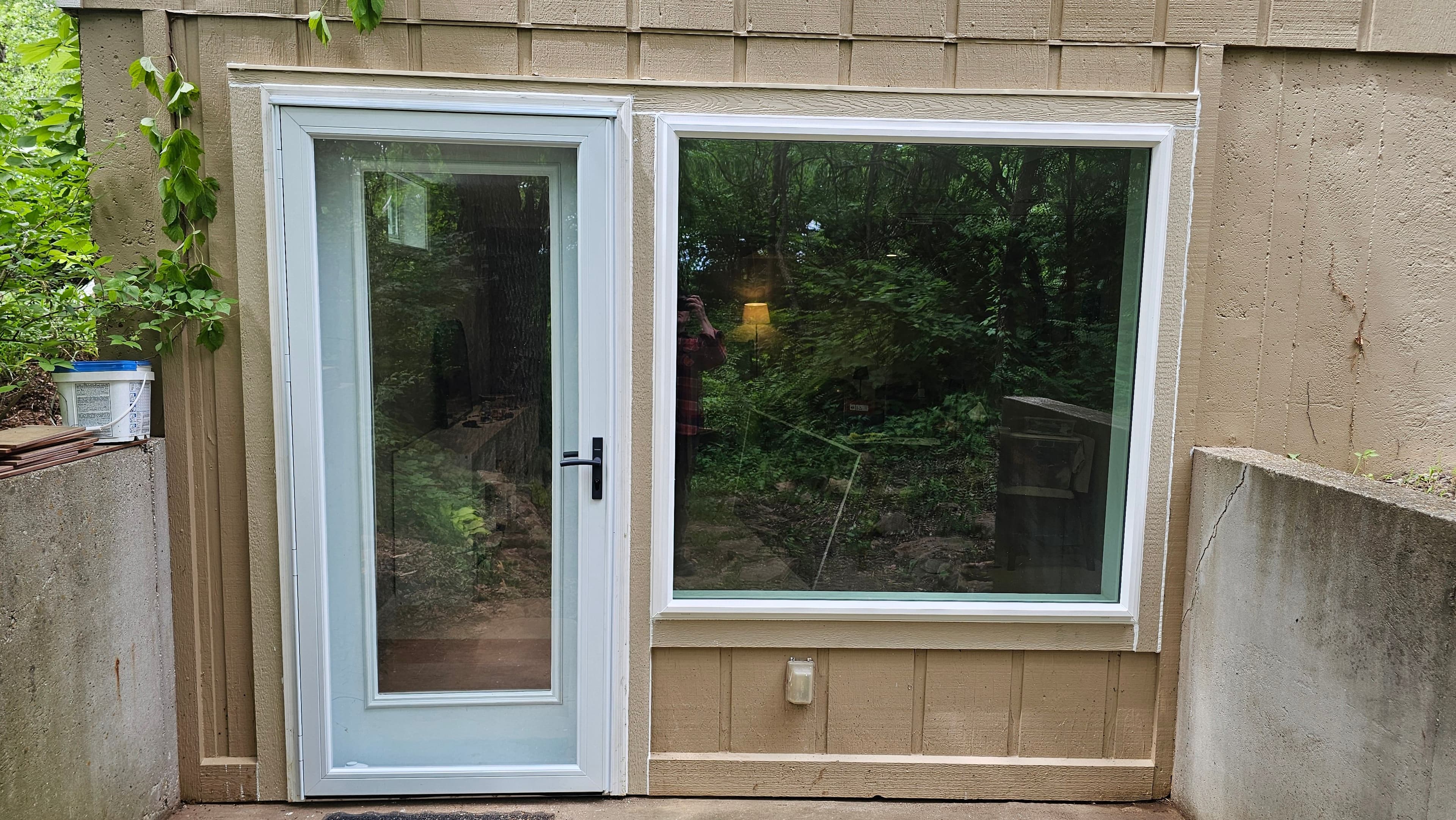White exterior entry door with new trim and Fixed window by GCB LLC